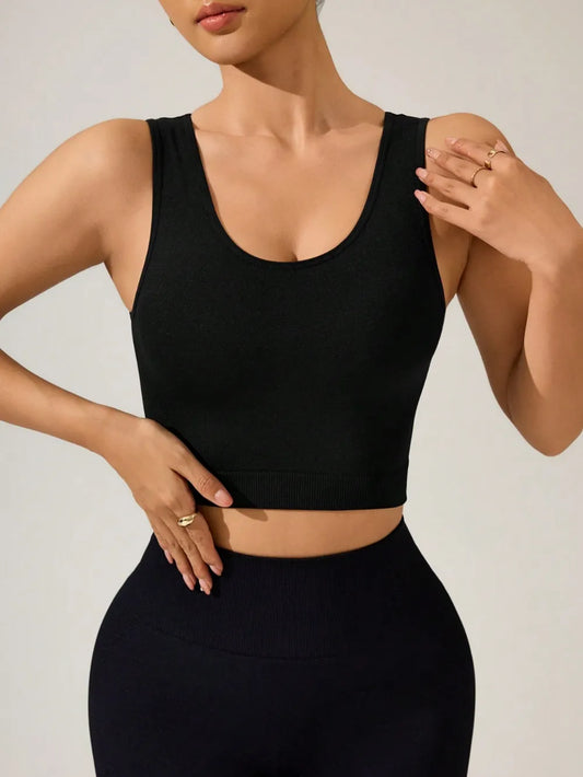oNMexis model wearing a black athletic crop tank top.