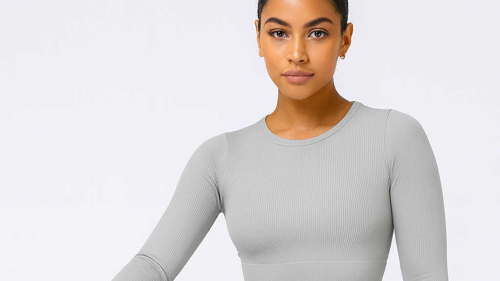 oNMexis model in gray athletic wear posing on a white background