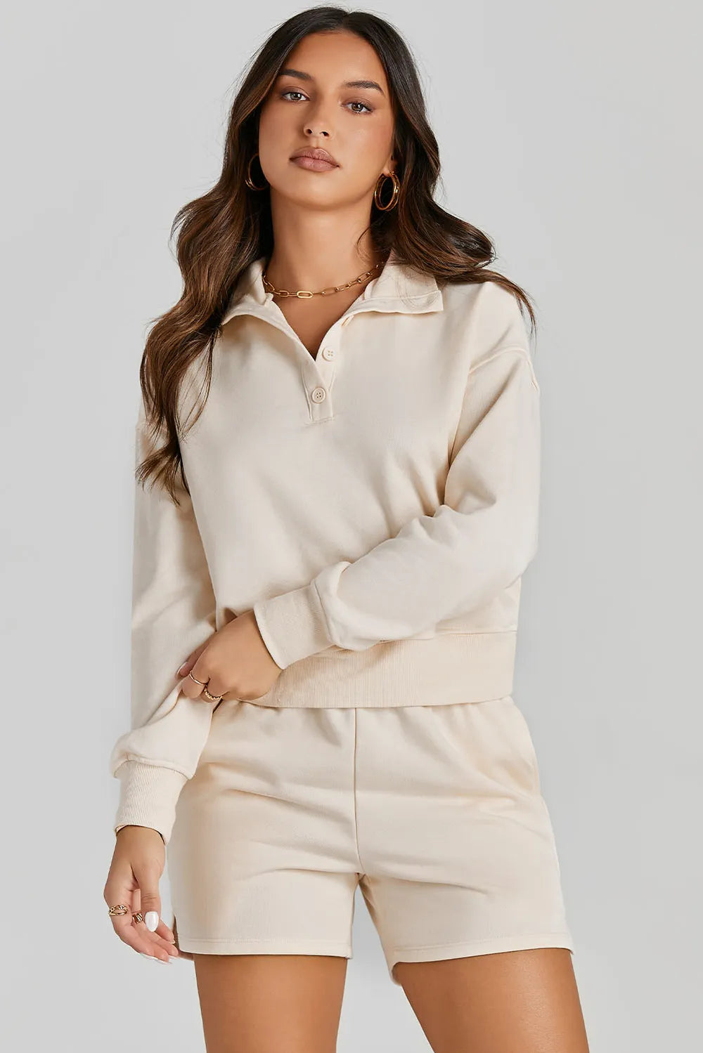 oNMexis female model wearing a half-button beige sweatshirt and shorts activewear set – casual workout outfit in soft fabric