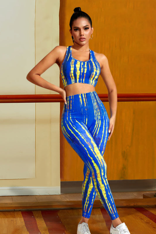 Woman wearing a blue and yellow tie-dye sports outfit in a studio setting.