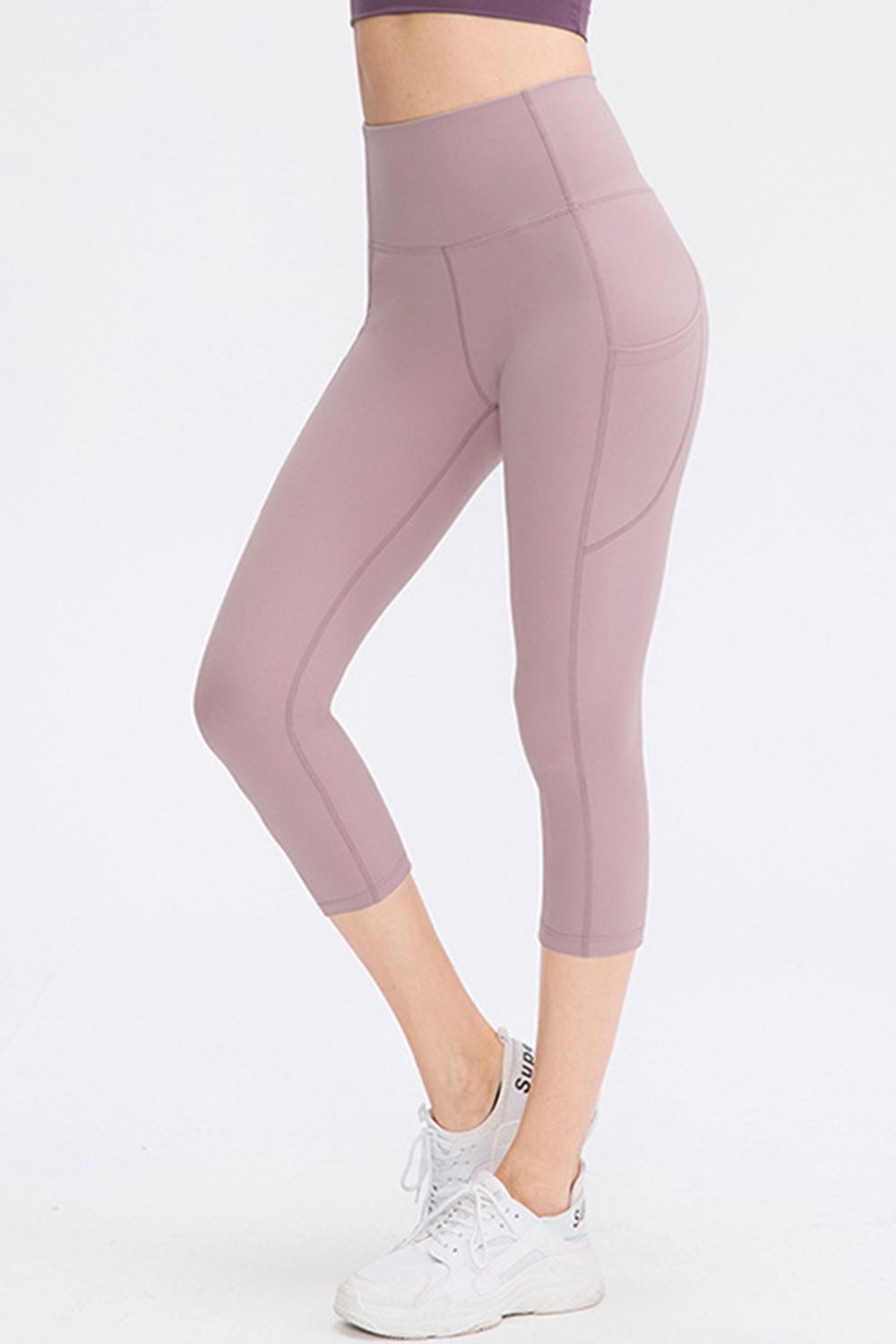 The front view features lilac cropped leggings, showcasing a deep pocket for women, made from athletic stretch fabric.