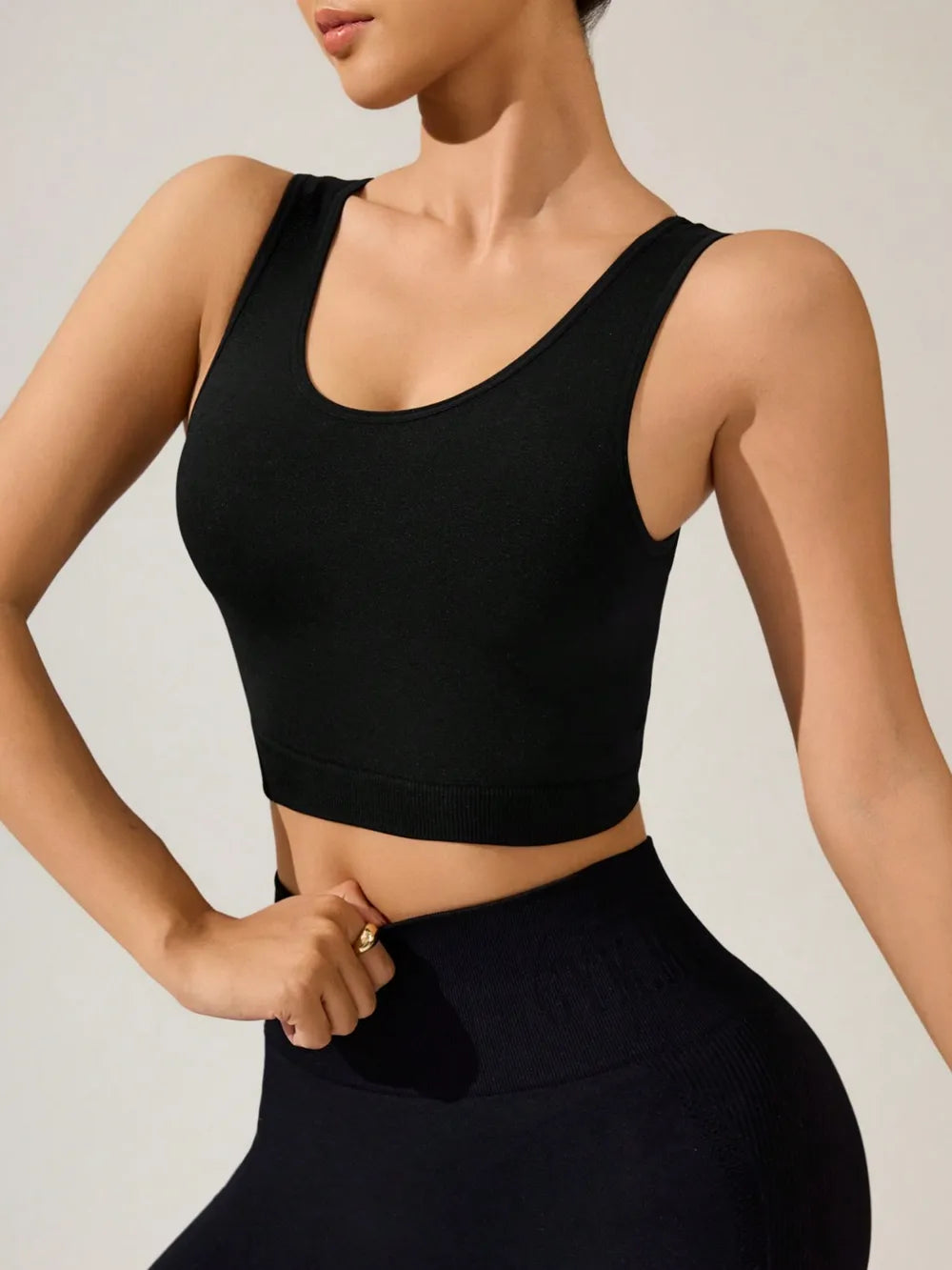 Black fitness tank top with a criss-cross design from the front