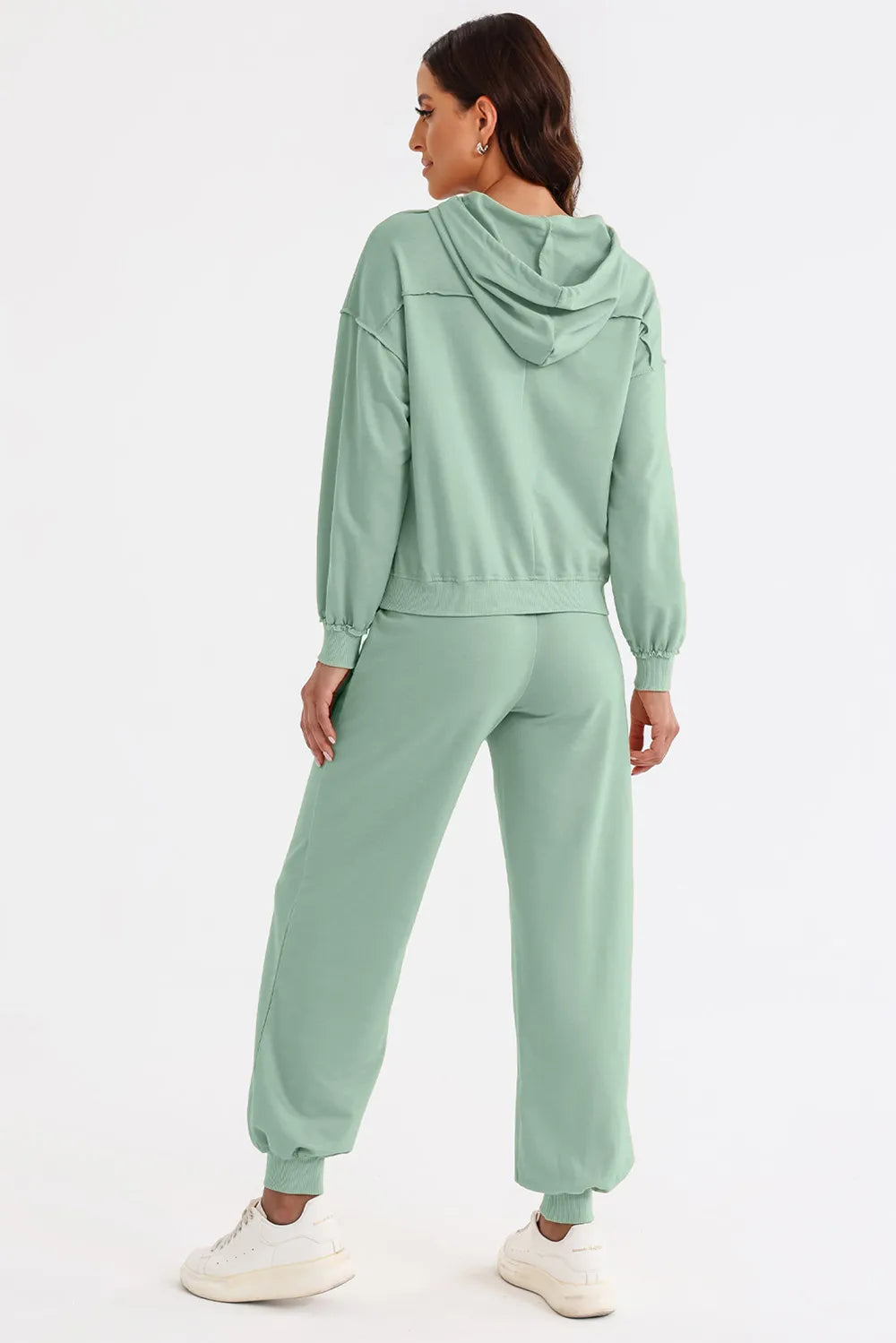 Person wearing a light green tracksuit